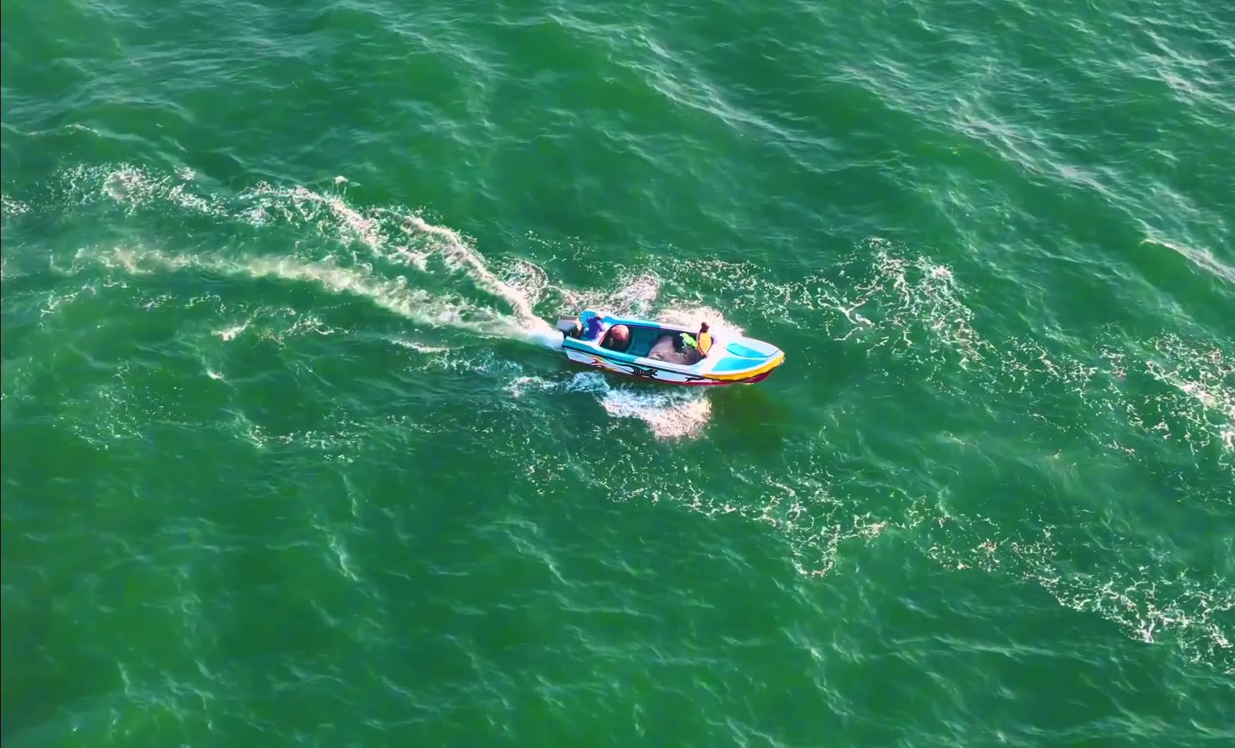 A small boat crossing the bright Indian Ocean