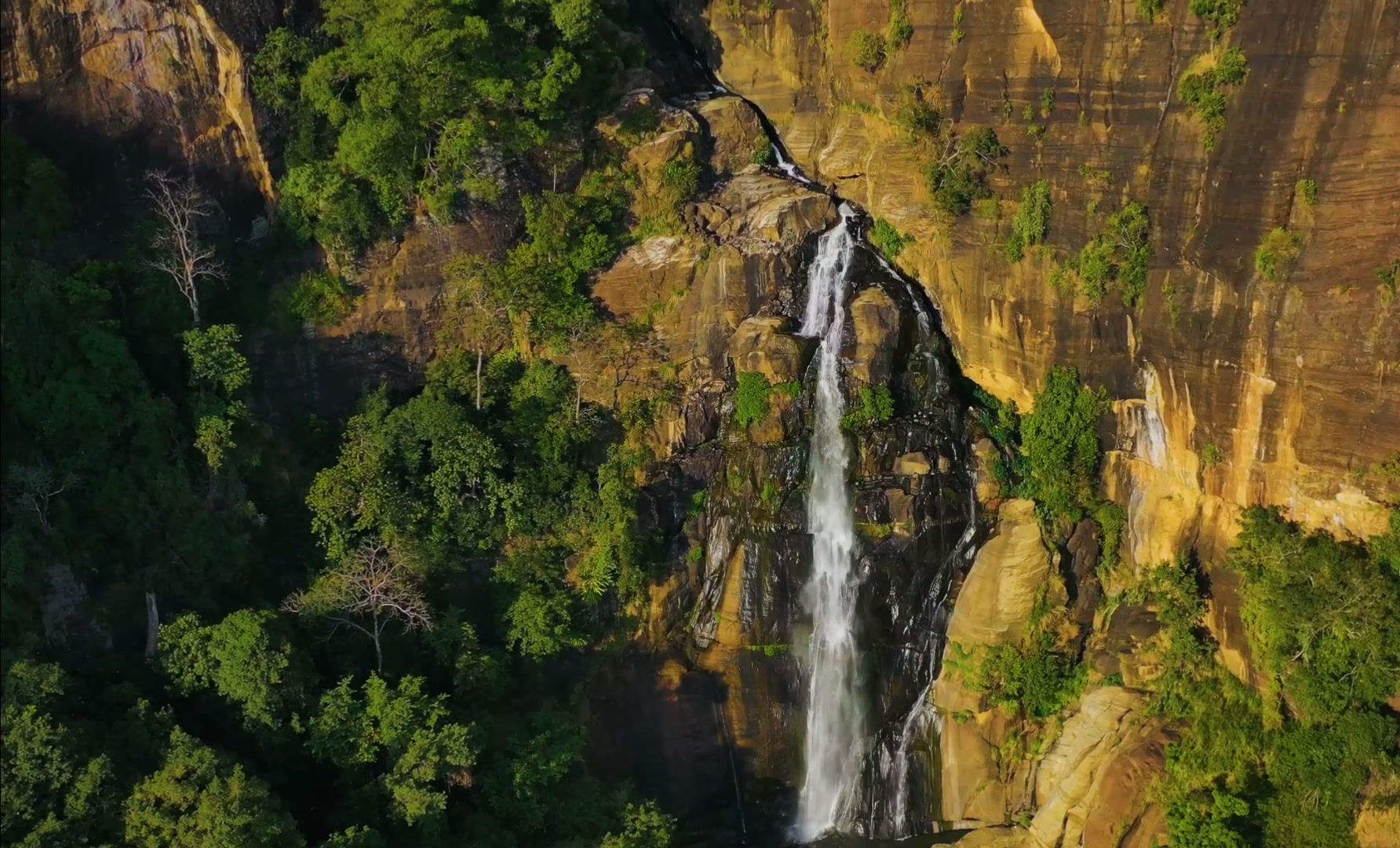 A waterfall dropping through Sri Lanka’s hill country